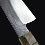 Side view of the Pandion Gyuto handmade knife, showcasing its sleek design and perfect balance.