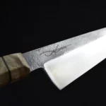 Dynamic angle of the Pandion Gyuto, showcasing its craftsmanship and sharp edge.