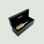 Armand De Brignac Brut Gold Champagne bottle inside its elegant black and gold gift box.