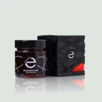 Jar of Greek Premium Raw Honey, Arbutus Wild Strawberry Honey, from Eulogia of Sparta with a rich golden color and unique label design.