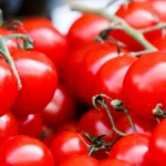 Ripe tomatoes on a kitchen counter, showcasing how easily a tomato knife or bread knife can slice through delicate skins
