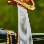 Gold-plated hilt and X50CrMoV15 stainless steel blade detail