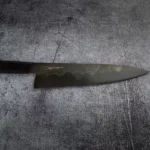 Close-up of the ergonomic 150 mm handle of the Handmade Gyoto Knife Cinyras, designed for comfortable grip and control during use.