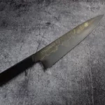 The Handmade Gyoto Knife Cinyras being used for slicing vegetables