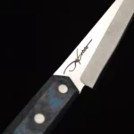 A close-up of the ergonomic handle of the Hyrieus handmade chef knife