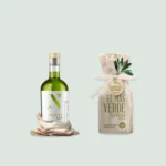 A bottle of El Más Verde Novo extra virgin olive oil showcasing its rich green color against a rustic background.